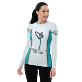 Woman wearing colorful Healing Hues rash guard at the beach.